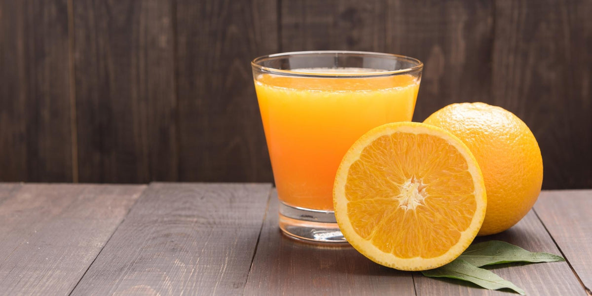 Orange Juice and Oranges on wooden table