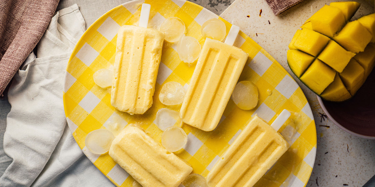Creamy mango popsicles on a plate