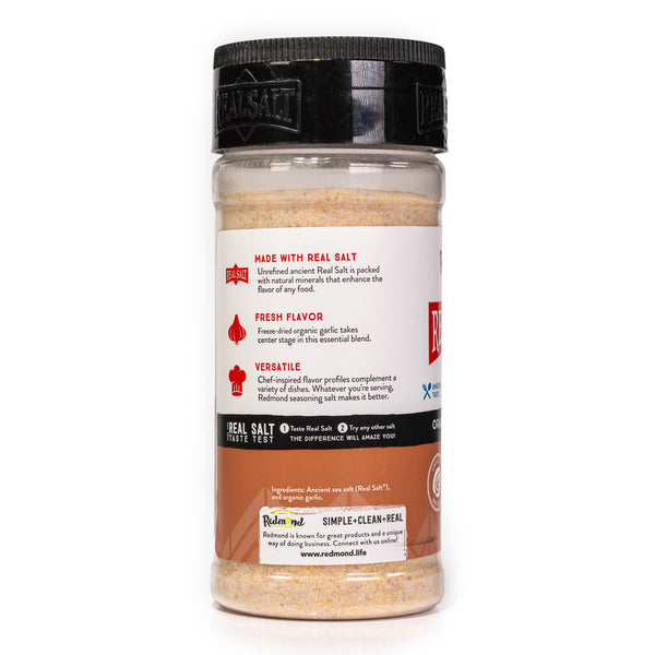 Clear shaker showcasing Redmond Real Salt's garlic salt, featuring a black lid and a label highlighting its natural, versatile flavor.