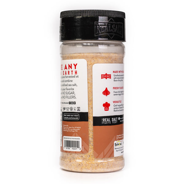 Clear plastic shaker of Real Salt brand organic seasoning showcasing nutritional information and brand details.