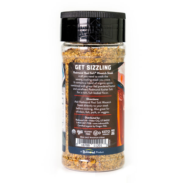 A clear jar displays a blend of Redmond Real Salt® Wasatch Steak seasoning, featuring a mix of spices and herbs ready to add savory flavor to any dish.