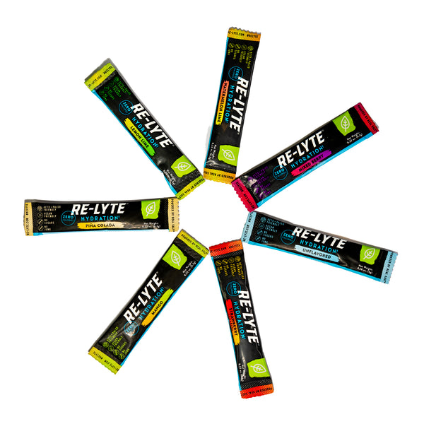 Seven flavors of individual Re-Lyte Hydration stick packs in a circle on white background.