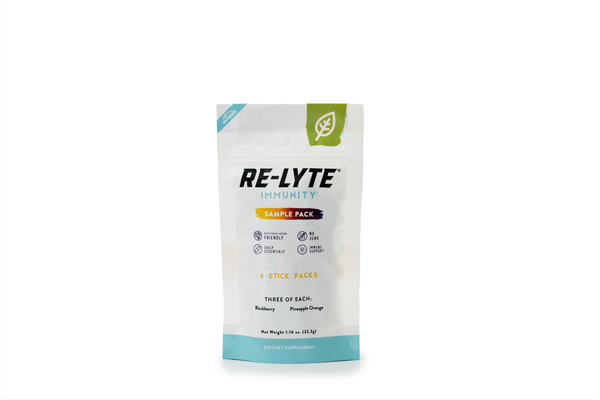 A white pouch of Re-Lyte Immunity sample pack dietary supplement stands upright, showcasing its keto-friendly, daily essentials, and immune support features.
