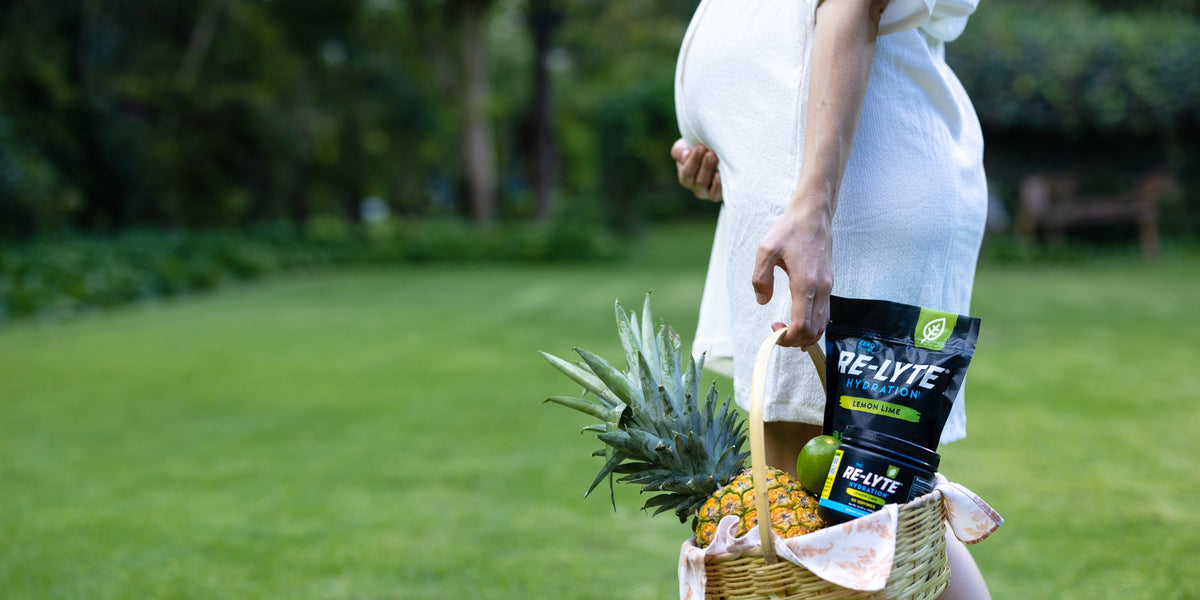 Pregnant woman holding basket with Re-lyte