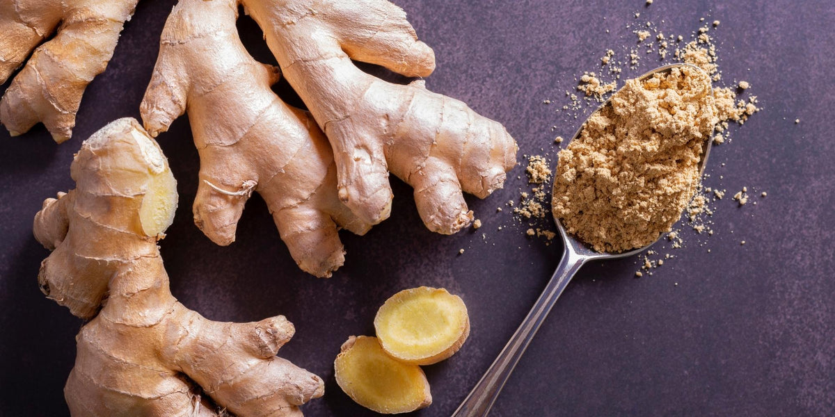 Whole ginger, cut ginger, and powdered ginger on a table