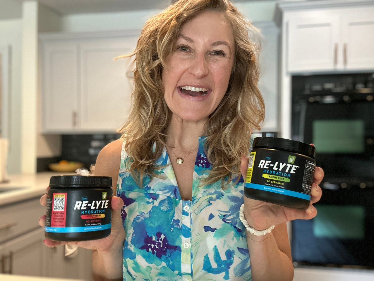 Whitney holding two Re-lyte jars 