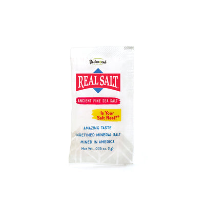 Single-serving packet of Redmond Real Salt, unrefined mineral sea salt mined in America. 
