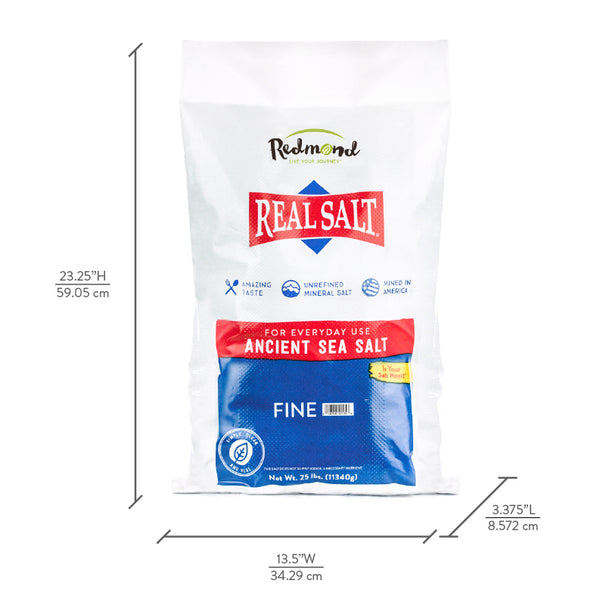 A bag of Redmond Real Salt, unrefined mineral sea salt, stands against a white background. 
