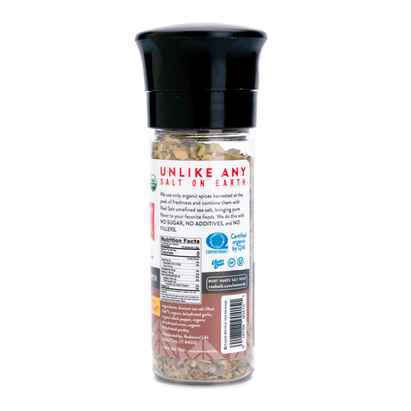Grinder bottle filled with Redmond Real Salt's organic garlic pepper seasoning.