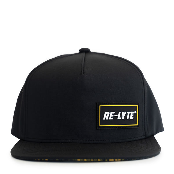 Black baseball cap displaying the Re-Lyte logo patch on the front right corner. image shown on a white background