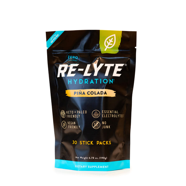 Piña Colada Re-Lyte Hydration 30 count stick packs electrolyte powder on white background. 