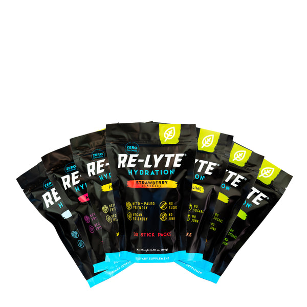 Seven flavor options of Re-Lyte Hydration 30 count stick packs electrolyte powder on white background. Flavors including: Piña Colada, Mixed Berry, Watermelon Lime, Mango, Unflavored, Lemon Lime and Strawberry Lemonade.